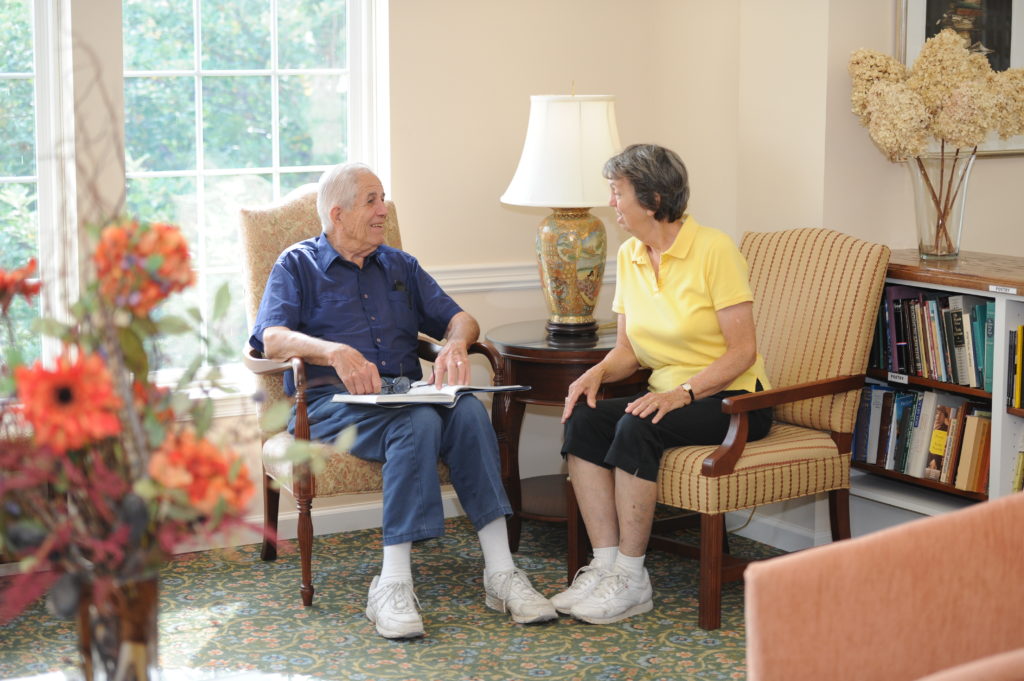 Resident couple conversing in the community center