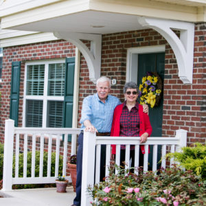 man and woman on cottage porch