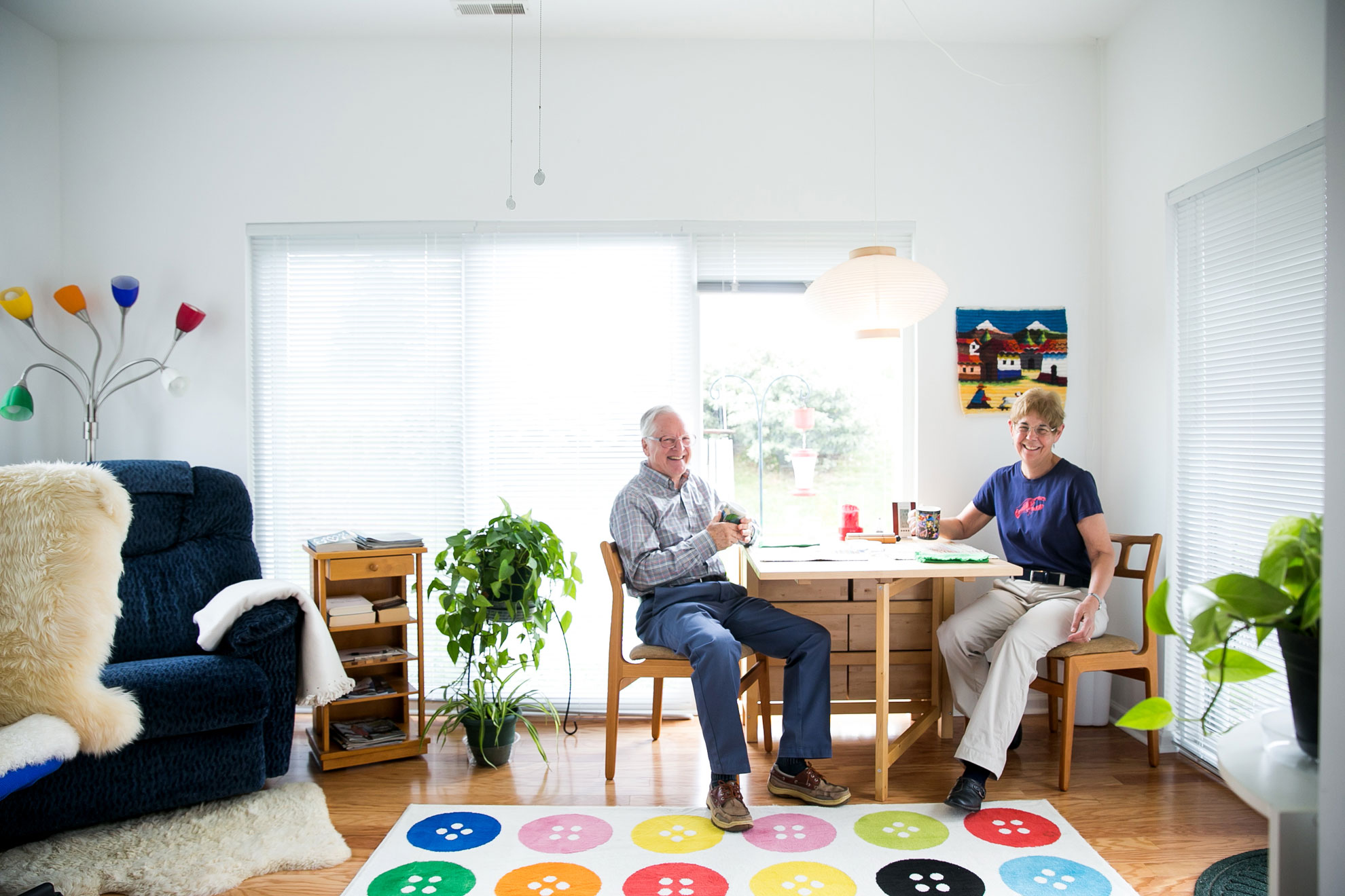 Couple drinking coffee at a table in their cottage