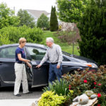 man and woman with car