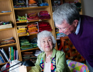 man and woman resident in quilt room