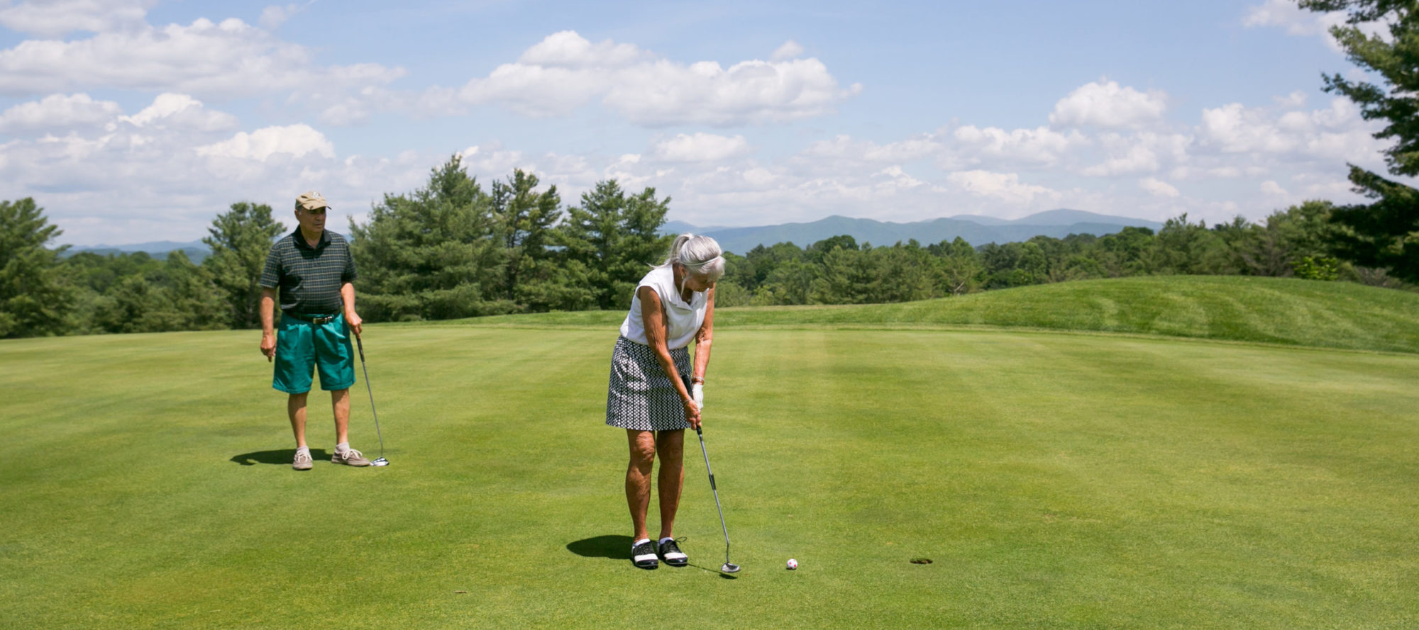 man and woman golfing