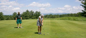 man and woman golfing