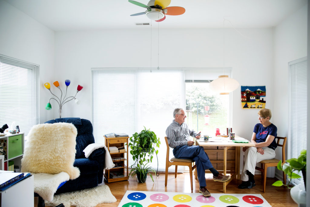 couple in colorful sunroom of cottage