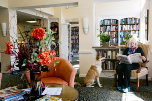 woman and dog in library