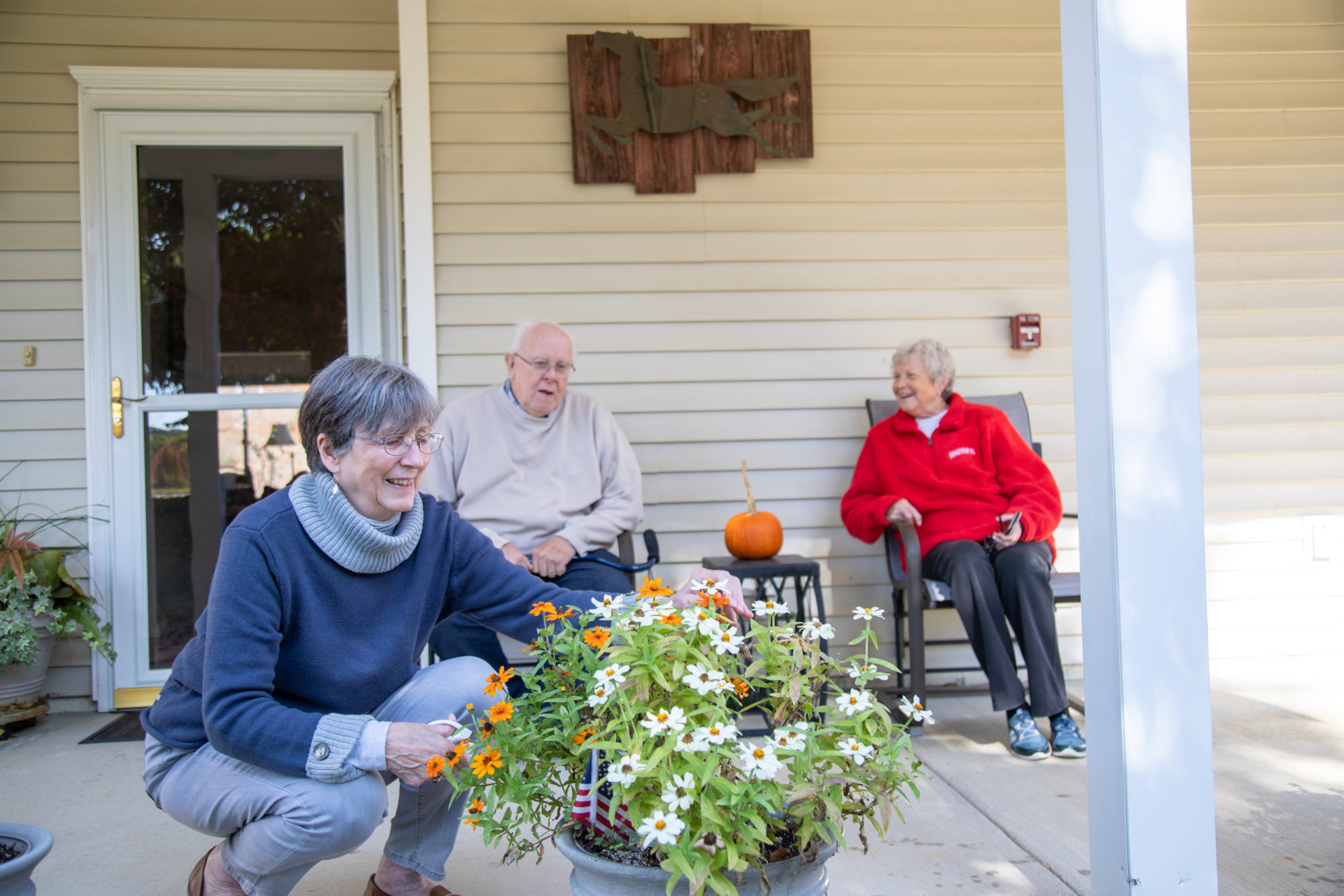 3 residents chanting on porch