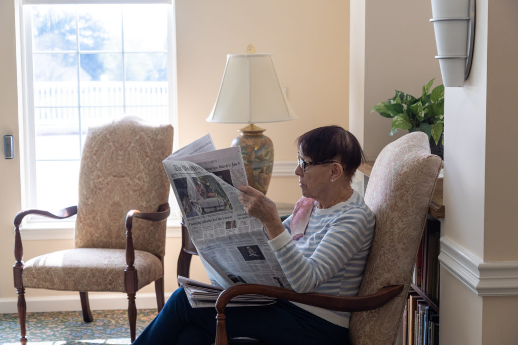 woman reading paper