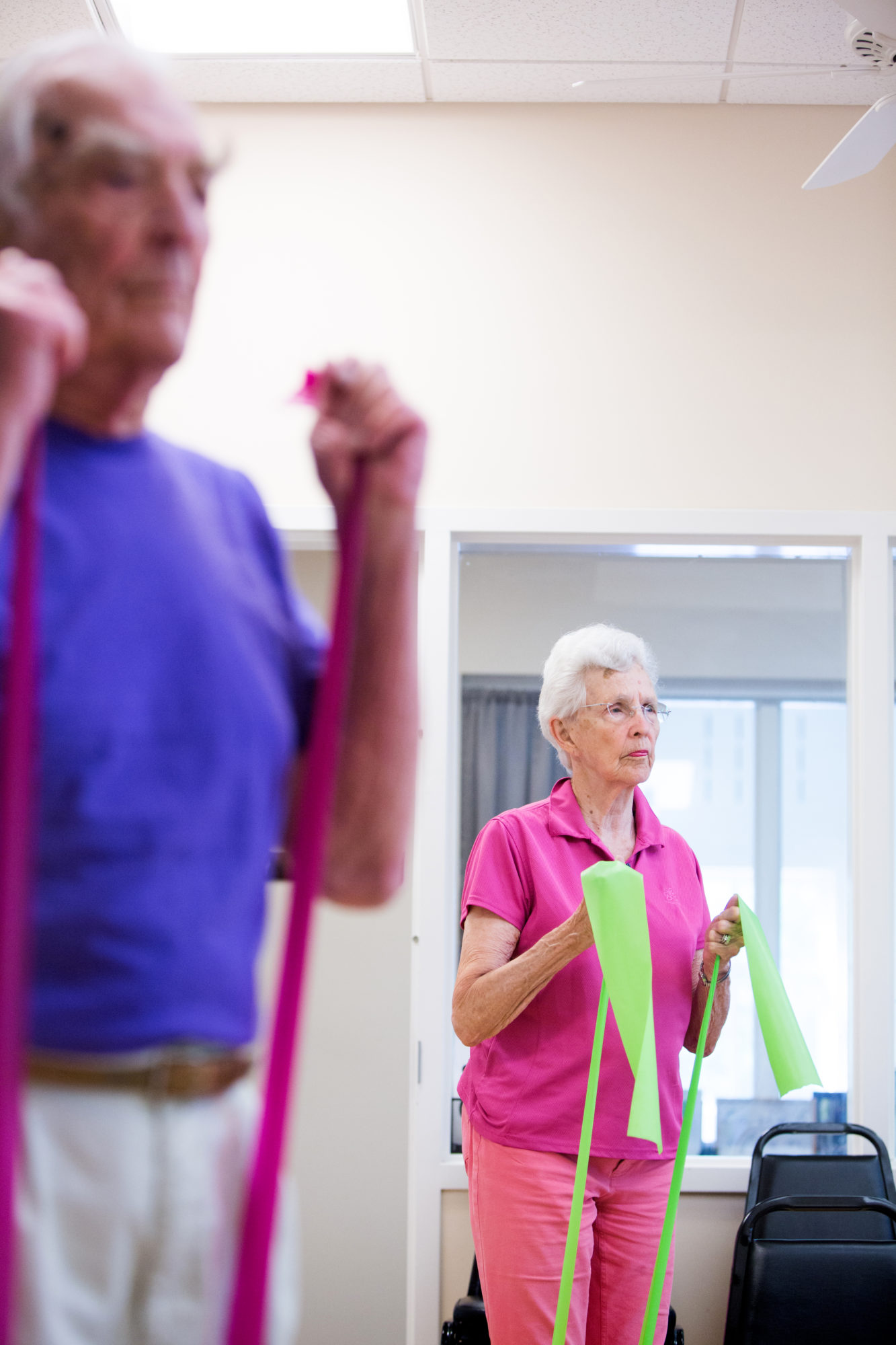 man and woman with strength bands