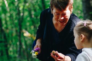 An image showing a grandmother talking to her grandchild affectionately, expressing love and happiness in their bond.
