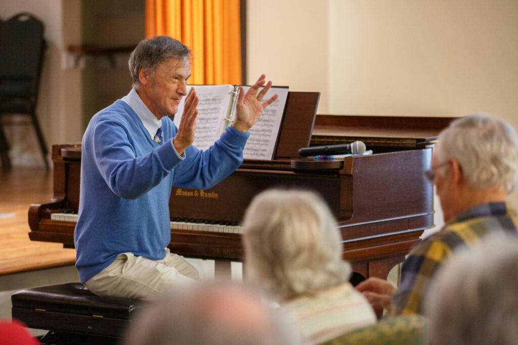 Tim Gaylard, retired professor from W&L, plays the piano for residents at a recital.